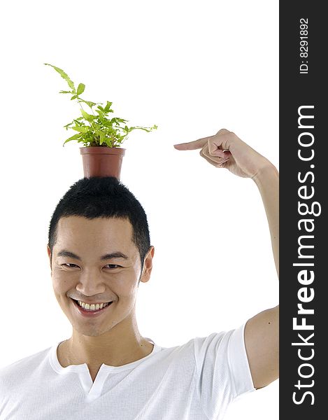 Close up of man with small plant on his head. Close up of man with small plant on his head