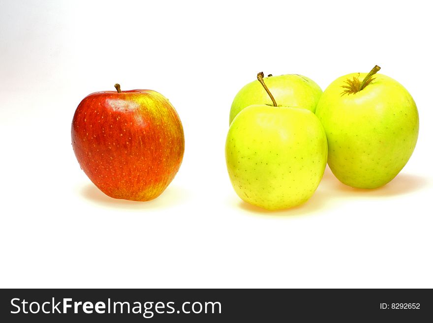 Single red apple with a group of green apples. Single red apple with a group of green apples