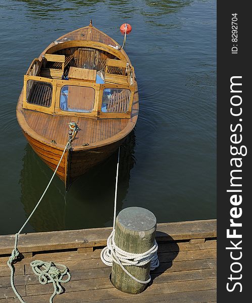 A small wooden boat docked in Oslo, Norway. A small wooden boat docked in Oslo, Norway