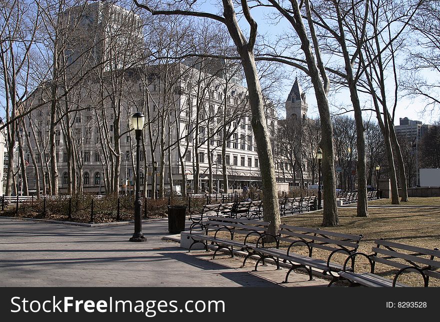 Tree lined paths in park, in downtown Brooklyn. With benches and lamps, court buildings in Background. Tree lined paths in park, in downtown Brooklyn. With benches and lamps, court buildings in Background