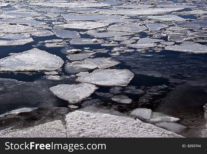 Sheets of ice floating on a lake in the middle of winter.