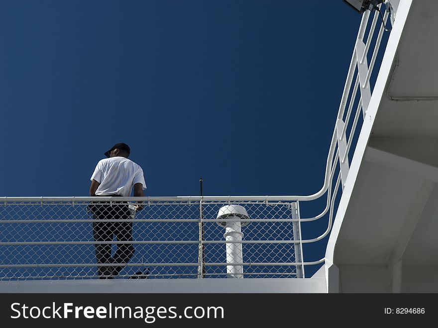 Man leans on ferry railing