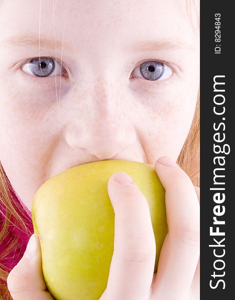 Close up of a girl biting an apple