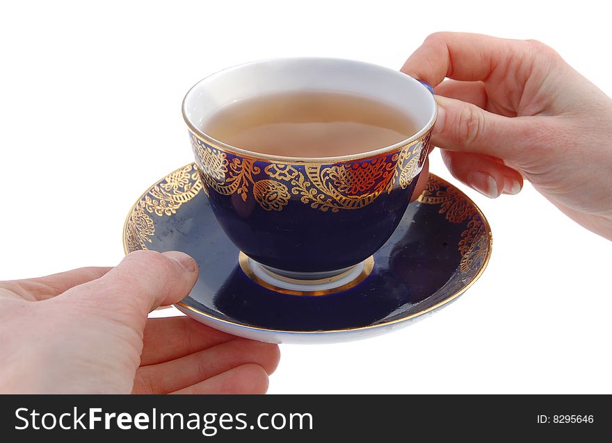 Arms holding cup and saucer