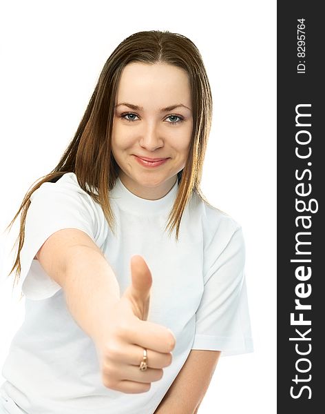 Beautiful young woman with her thumb up against white background