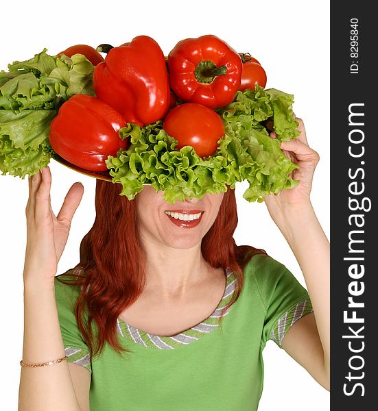 The young woman holds fresh vegetables on a head. The young woman holds fresh vegetables on a head