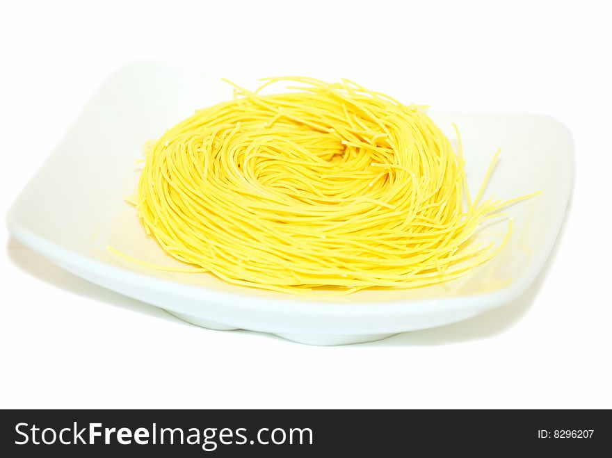 German pasta nest on white background.