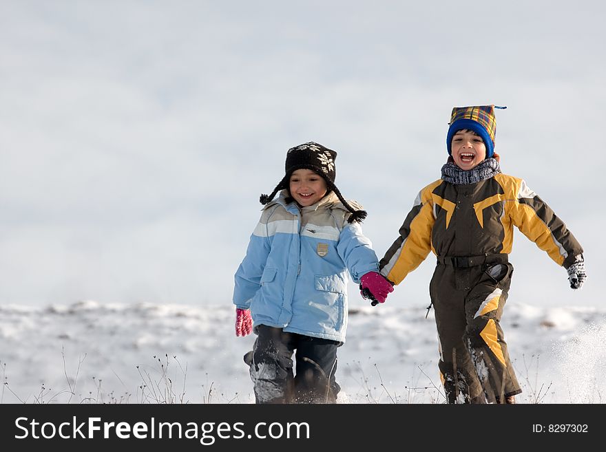 Little girl and boy running through the snow. Little girl and boy running through the snow.