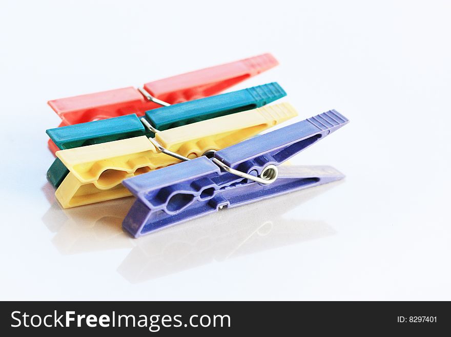 Four colored clothespin with reflection. Four colored clothespin with reflection
