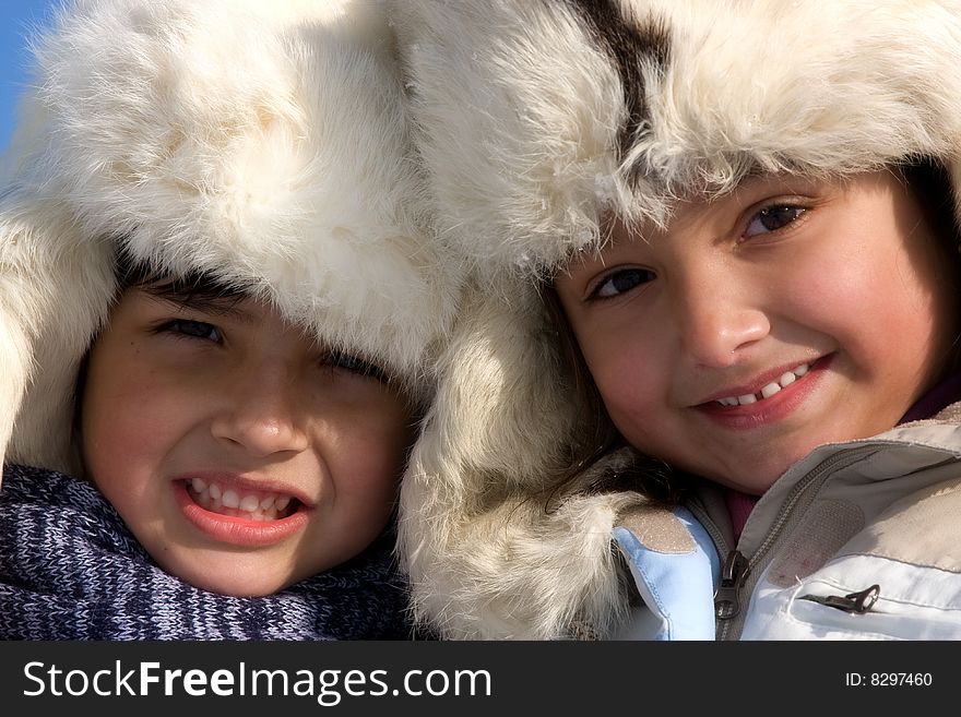 Portrait Of Little Girl And Boy In The Fur-cap