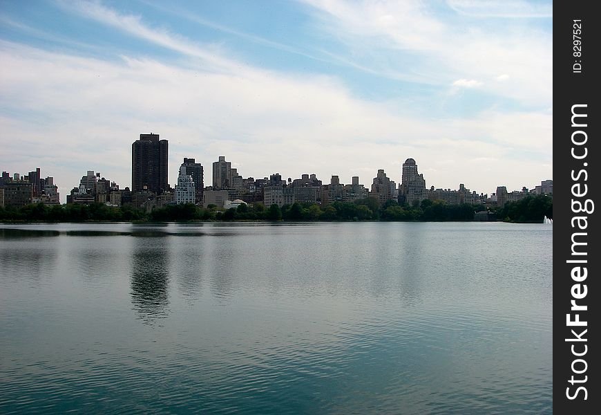 A picture of NYC over the Jacqueline Onassis Reservoir with a little reflection from the water. A picture of NYC over the Jacqueline Onassis Reservoir with a little reflection from the water.