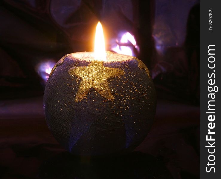 Candle with star in the dark