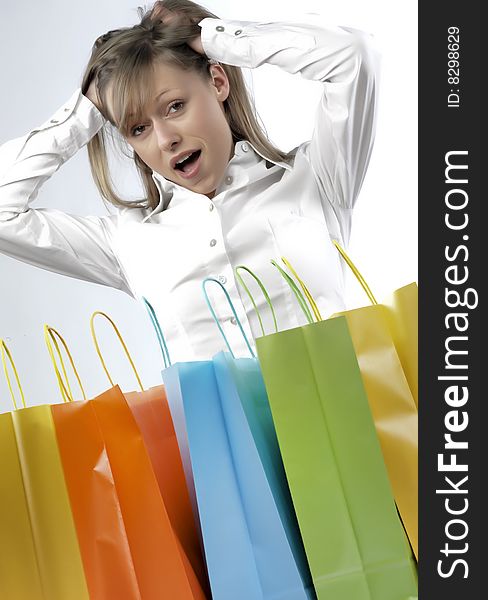 Portrait of an attractive young woman holding several shoppingbags. Portrait of an attractive young woman holding several shoppingbags.