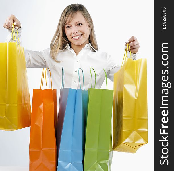 Portrait of an attractive young woman holding several shoppingbags. Portrait of an attractive young woman holding several shoppingbags.