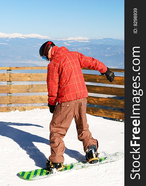 Snowboarder - young man on the ski slope. Snowboarder - young man on the ski slope