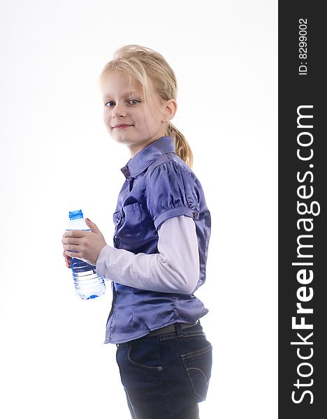 Little pretty young smiling  girl with bottle fresh water on a white studio background. Little pretty young smiling  girl with bottle fresh water on a white studio background.