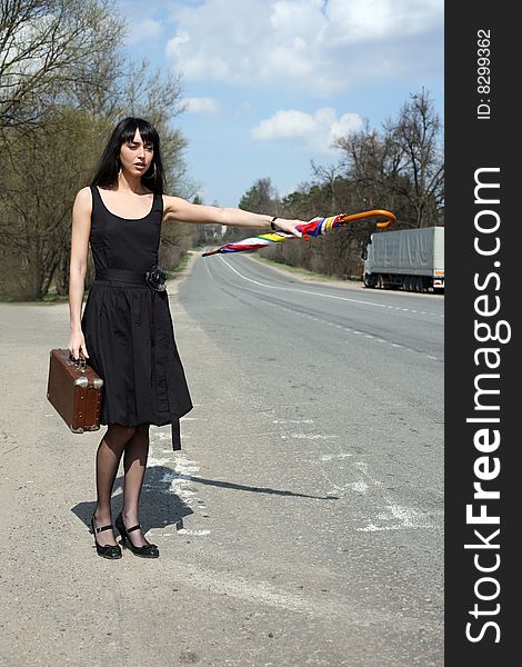 Girl with vintage suitcase and umbrella outdoors. Girl with vintage suitcase and umbrella outdoors