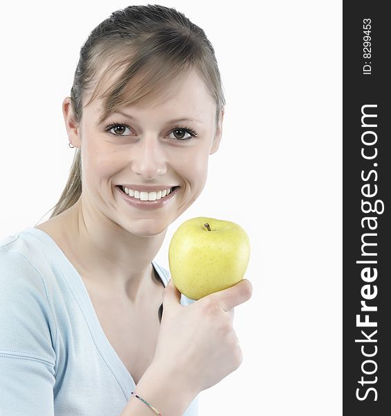 Beautiful young woman holding a green apple