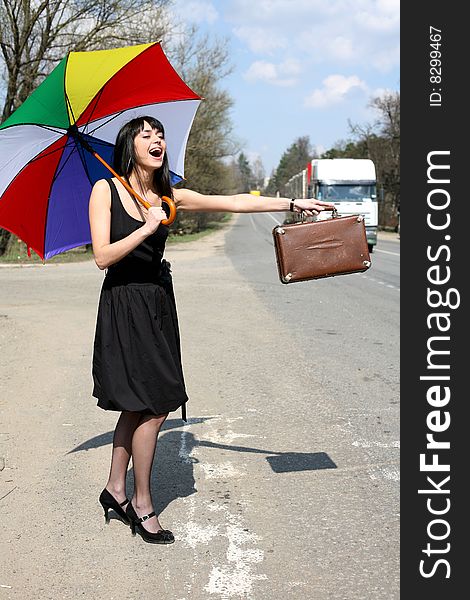 Girl with vintage suitcase and umbrella outdoors. Girl with vintage suitcase and umbrella outdoors