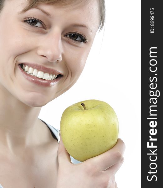 Beautiful young woman holding a green apple