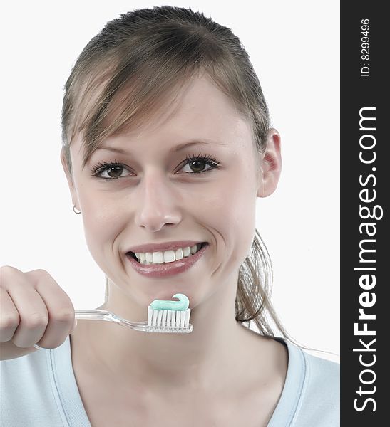 Woman brushing her teeth, studio white