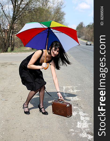 Girl with vintage suitcase and umbrella outdoors. Girl with vintage suitcase and umbrella outdoors