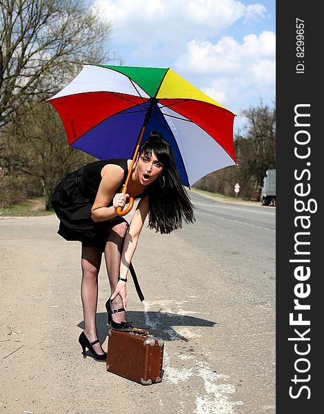 Girl with vintage suitcase and umbrella outdoors. Girl with vintage suitcase and umbrella outdoors