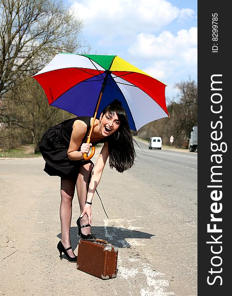 Girl with umbrella at road. Girl with umbrella at road