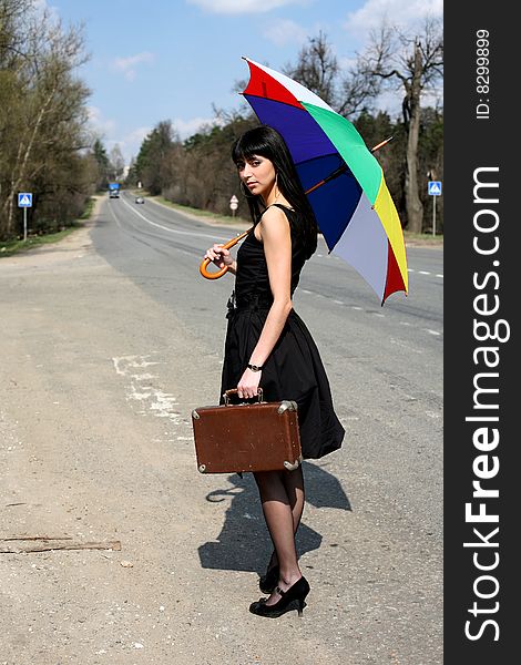 Girl with vintage suitcase and umbrella outdoors. Girl with vintage suitcase and umbrella outdoors