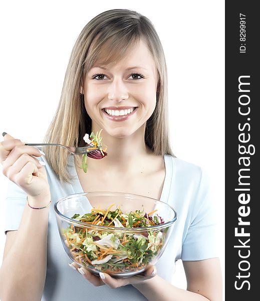 Portrait of young happy woman eating salad