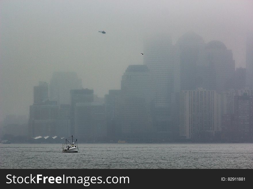 Foggy waterfront of Manhattan, New York City, NY with boat and helicopter. Foggy waterfront of Manhattan, New York City, NY with boat and helicopter.