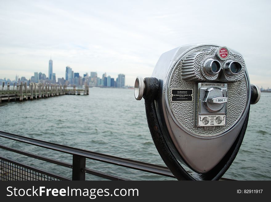 A tourist viewfinder overlooks a harbour.