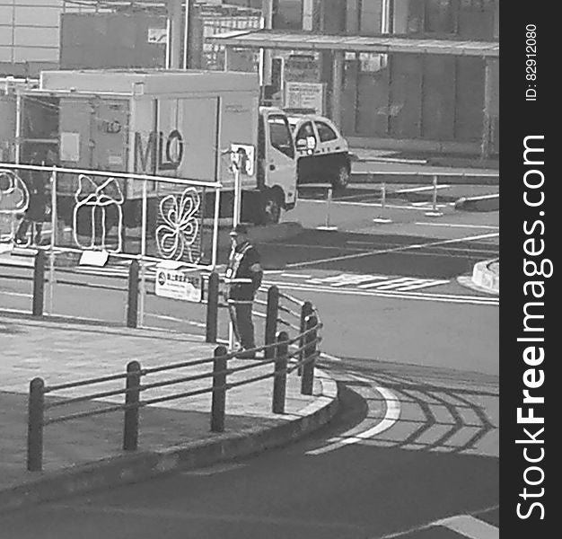 Man standing on corner of city street with holiday decorations in black and white. Man standing on corner of city street with holiday decorations in black and white.