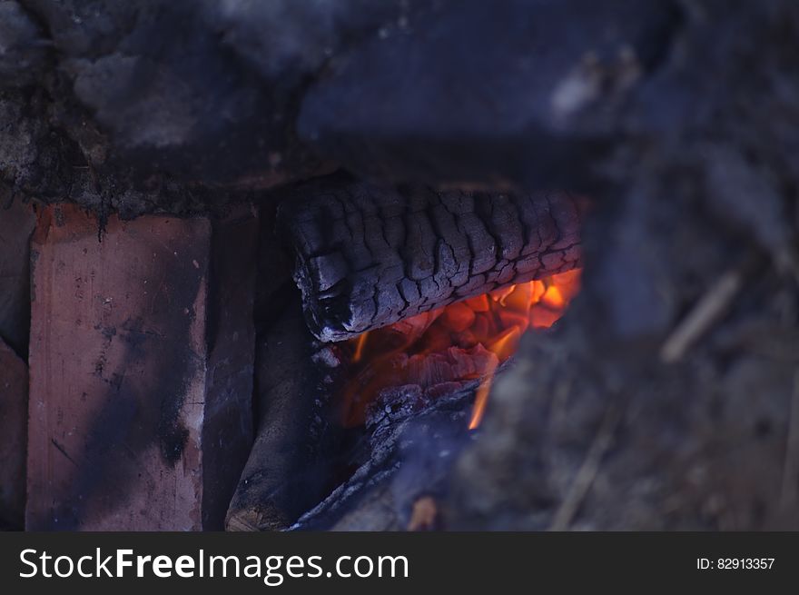 Close up of glowing embers in wood fire. Close up of glowing embers in wood fire.