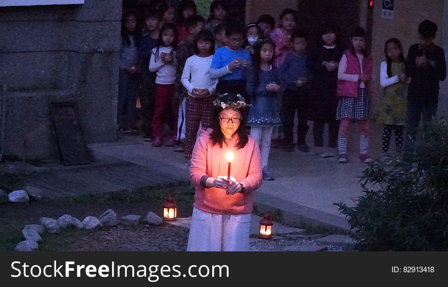 Girl With Candle In Ceremony