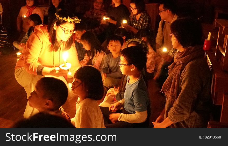 Children in candle lighting ceremony indoors. Children in candle lighting ceremony indoors.