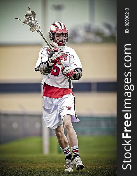 Person Holding Lacrosse Stick during Daytime