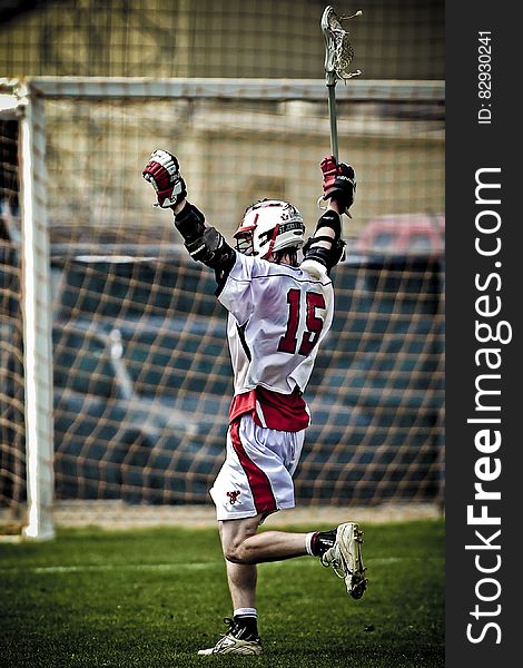 Man Holding Lacrosse Running Towards Goal