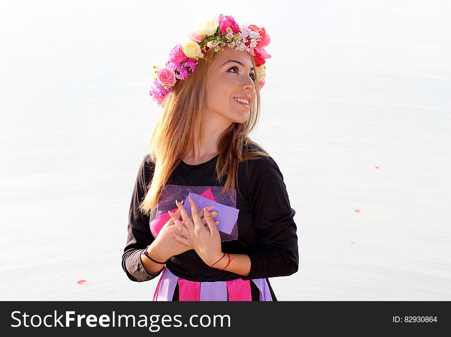 Woman in Black Purple and Pink Long Sleeve Dress and Pink Yellow and Beige Rose Headdress