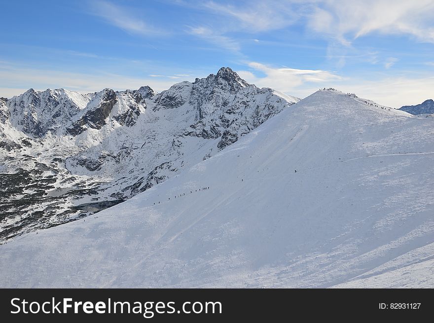 Alpine hikers on snowy mountain