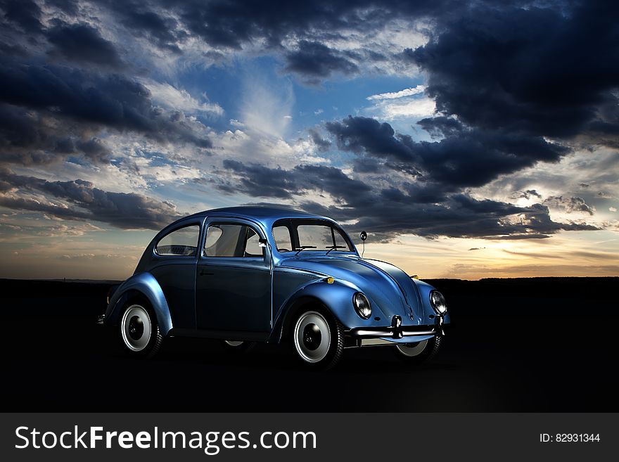 Blue Volkswagen Beetle Under Blue Sky and White Clouds during Golden Hour