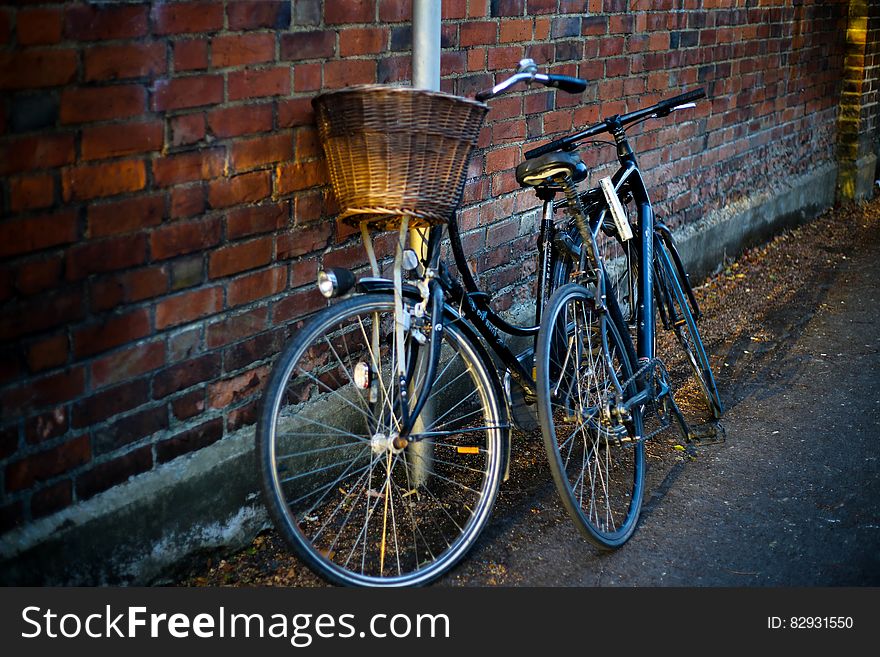 Bicycles leaning against brick wall in alley. Bicycles leaning against brick wall in alley.