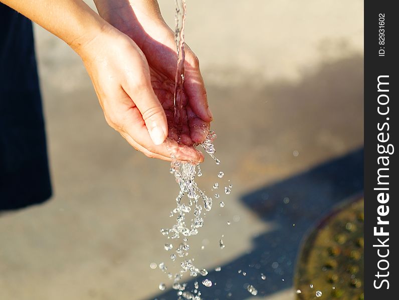 Water Pouring On Person&x27;s Hand