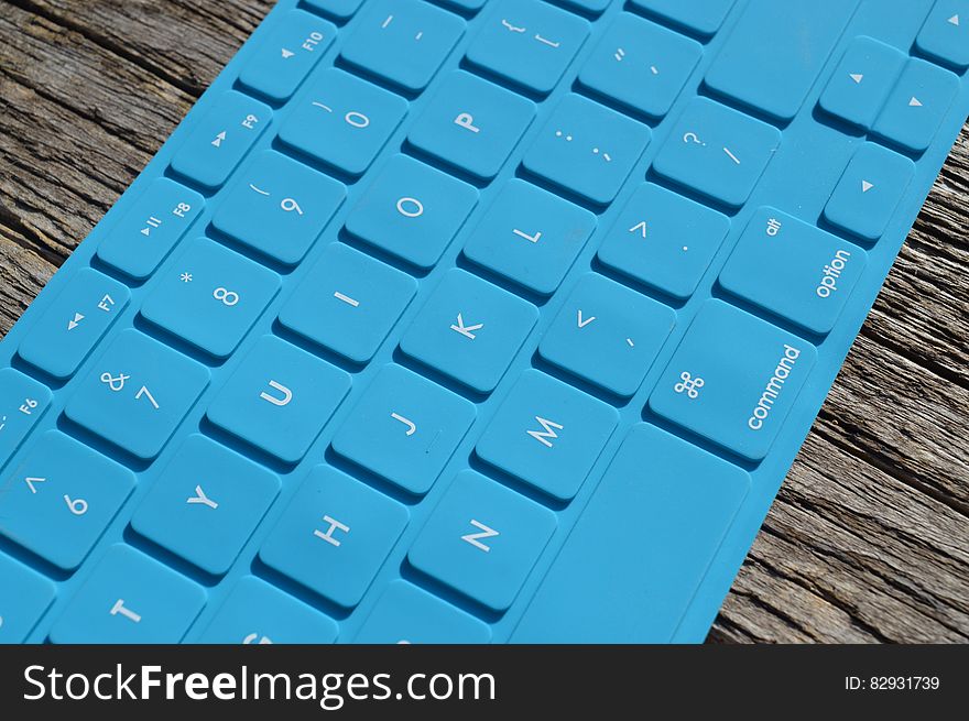 Blue Computer Keyboard on Gray Wooden Surface