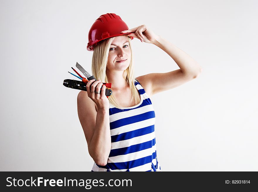 Woman In Blue And White Tank Top Wearing Red Hard Hat