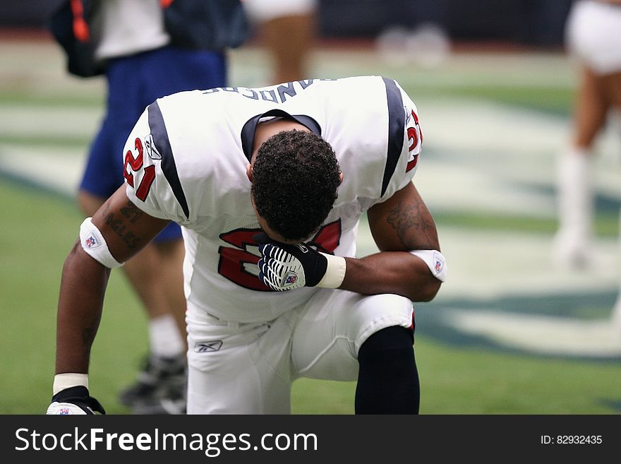 Football Player on Bended Knees