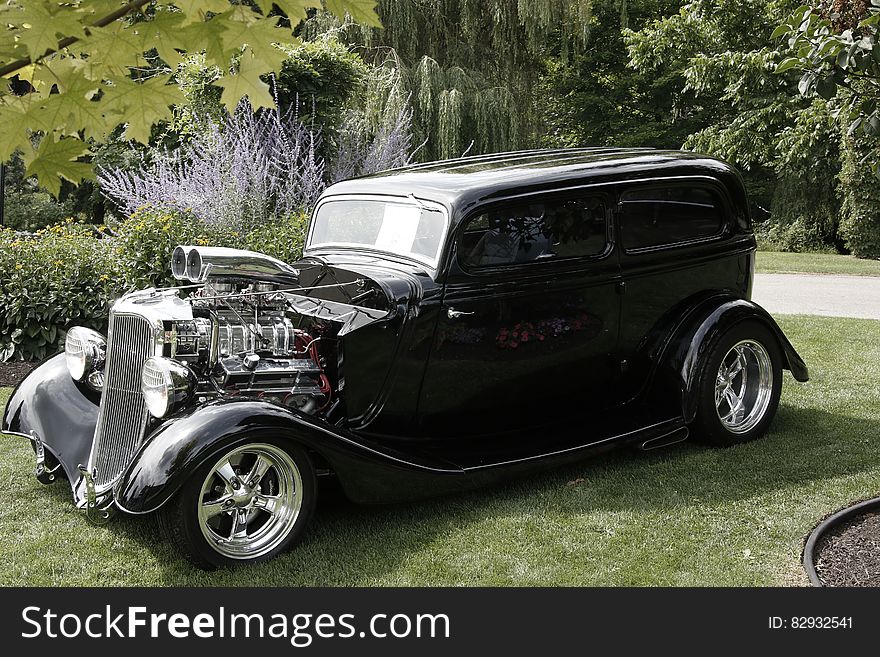 Black Classic Car in Green Grass during Daytime