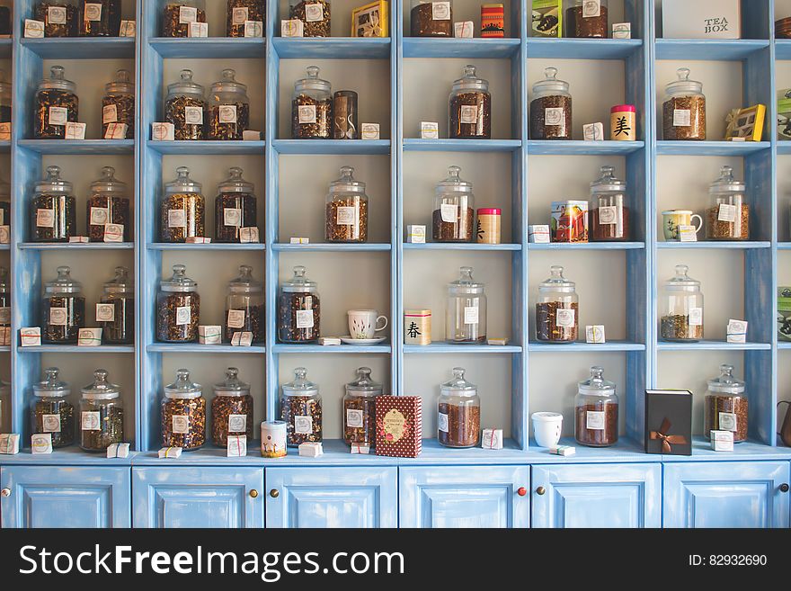 Assorted Jars on Blue Shelf Cabinets