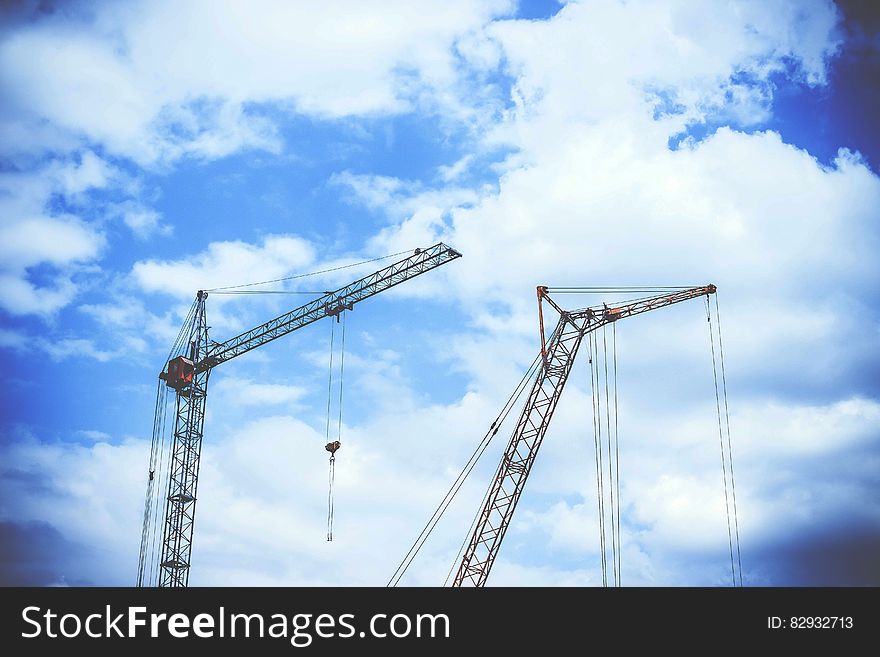 Gray Rectangular Power Crane With Blue Cumulus Clouds Above As Background during Daytime