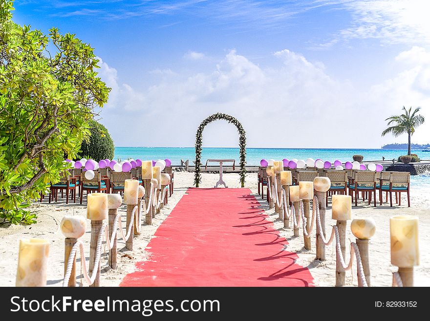 Beach Wedding Event Under White Clouds and Clear Sky during Daytime